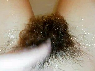 Hairy pussy lips glisten underwater in close-up fetish pool tease