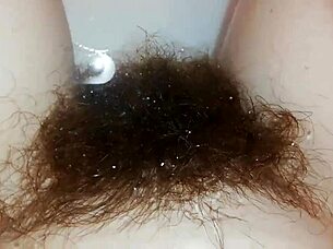 Hairy pussy lips glisten underwater in close-up fetish pool tease