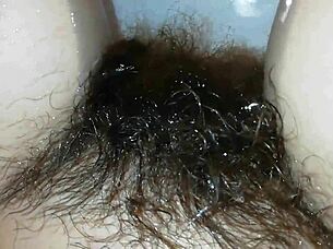 Hairy pussy lips glisten underwater in close-up fetish pool tease