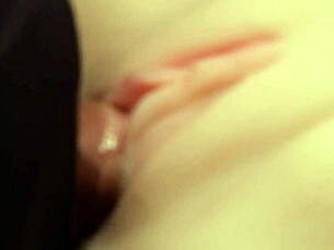 Flushing lube deep into shaved pussy close-up