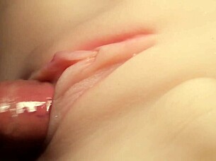 Flushing lube deep into shaved pussy close-up