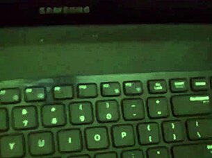 A dancer sways seductively in dim light