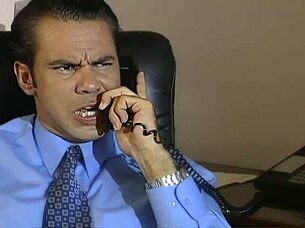 brunette secretary bends over desk