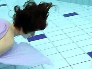 Blackhaired Aneta Splashes Nude In Pool Depths