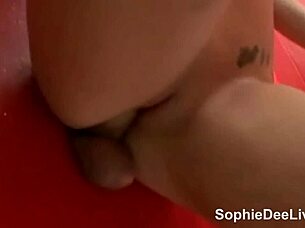 sophie dee crams gloryhole cock between her huge melons