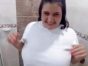 playing in bathroom wearing tight shirt while fingering wildly