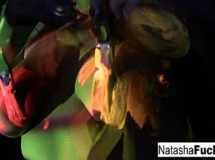Busty brunette Natasha Nice glows in sexy black light solo tit tease