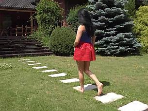 She teases garden breeze under short skirt