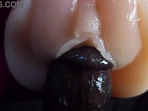 oiled big black dildo pounds fuck doll slow motion closeup