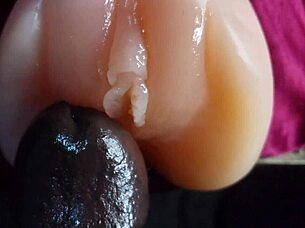 oiled big black dildo pounds fuck doll slow motion closeup