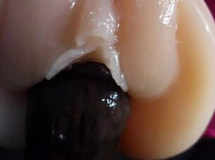 oiled big black dildo pounds fuck doll slow motion closeup