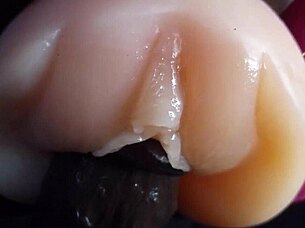 oiled big black dildo pounds fuck doll slow motion closeup