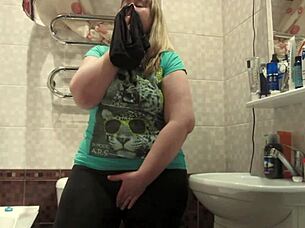 Chubby milf sniffs panties then stuffs them deep in hairy pussy fingering wildly.