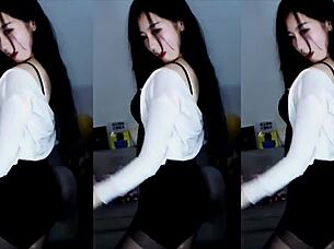 sexy chinese girl dances provocatively on stage