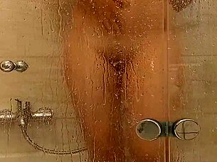 She caresses herself relaxing in the bath