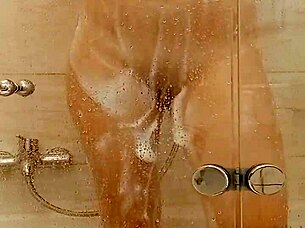 She caresses herself relaxing in the bath