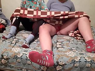 Mutual masturbation under covers while parents watch movie nearby