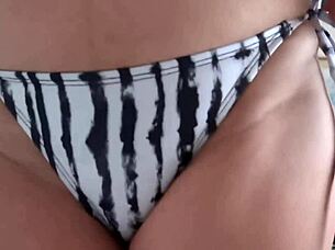 mature blonde milf masturbates wildly on beach eyeing bikini-clad temptress