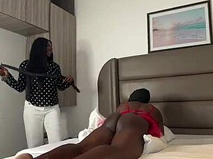 Ebony mistress spanks humiliated slave ass