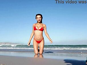 gorgeous brunette gloria sol strips outdoors on beach