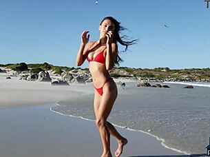 gorgeous brunette gloria sol strips outdoors on beach