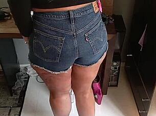 Tanned Beauty Poses in Tight Shorts Revealing Subtle Tan Lines