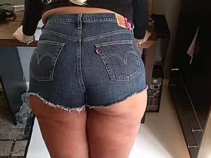 Tanned Beauty Poses in Tight Shorts Revealing Subtle Tan Lines