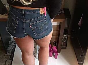Tanned Beauty Poses in Tight Shorts Revealing Subtle Tan Lines