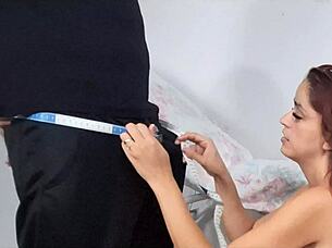 seamstress eyes client's bulge while measuring pants teasingly