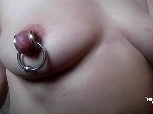 kinky milf stretches extreme pierced nipples close up rings?