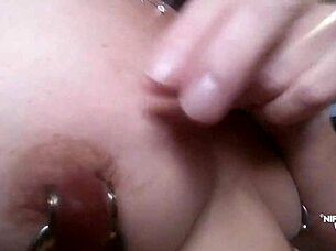 kinky milf stretches extreme pierced nipples close up rings?