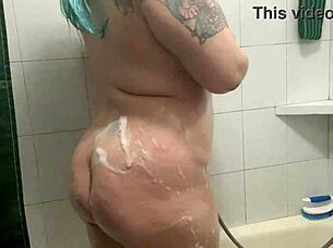 Chubby tattooed babe teases dripping shower curves