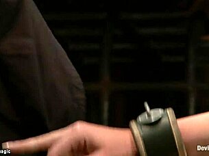 Redhead's neck trapped tight in kinky bondage device