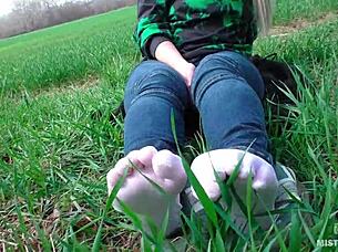 goddess's cute white socks feet tease in jeans on spring grass outdoors 👣😍