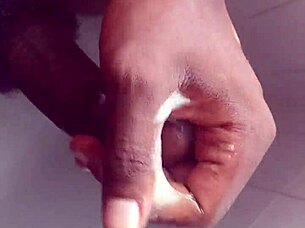 Hey, check out this black babe showering and masturbating her big tits