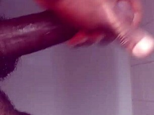 Hey, check out this black babe showering and masturbating her big tits