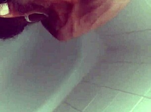 Hey, check out this black babe showering and masturbating her big tits