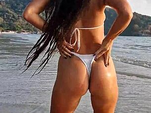 Petite beauty flashes sexy white bikini on beach publicly
