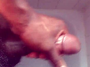 Hey, check out this black babe showering and masturbating her big tits