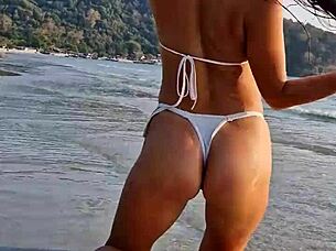 Petite beauty flashes sexy white bikini on beach publicly