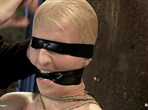 Busty blond in chair bondage rubbed with firm hands
