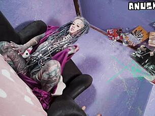 tattooed model teases with anal toys