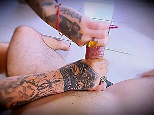 tattooed hands stroke cock close up with rings