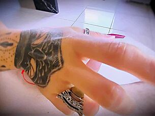 tattooed hands stroke cock close up with rings