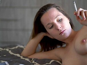 petite brunette smokes in bed baring perky tits
