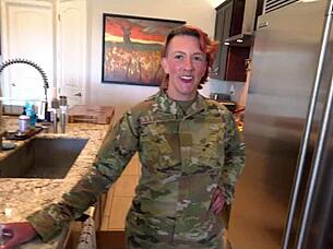 Military woman trains young man in bedroom
