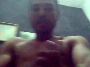 muscular guy strokes his cock hard