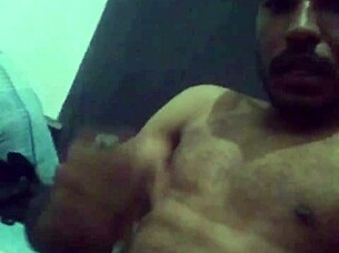 muscular guy strokes his cock hard