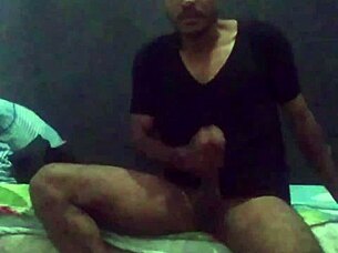 muscular guy strokes his cock hard