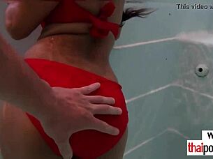 An Asian European couple enjoys pool fun and gets excited afterward.